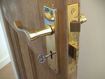 A new lock and key fitting on a door